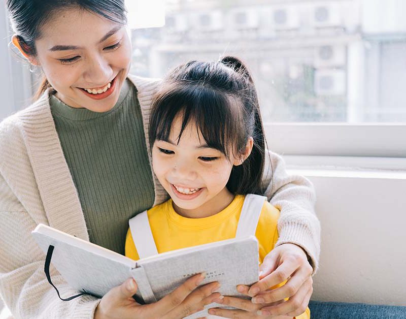 Mother and daugther practising chinese oral